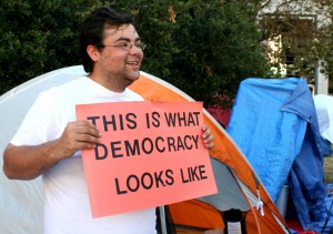 M.J. Delacruz chats with his neighbors in front of his "revolutionary spooner" tent at the Occupy Oakland camp. 