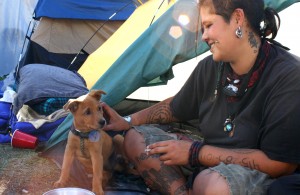 Charmz Valentino is living at Occupy Oakland with her puppy Tucker, a favorite among fellow campers.